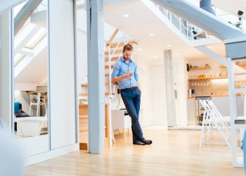 Handsome business at home holding phone