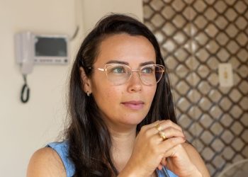 Trabajadora remota latina en su escritorio, afectada por la regla de conveniencia del empleador