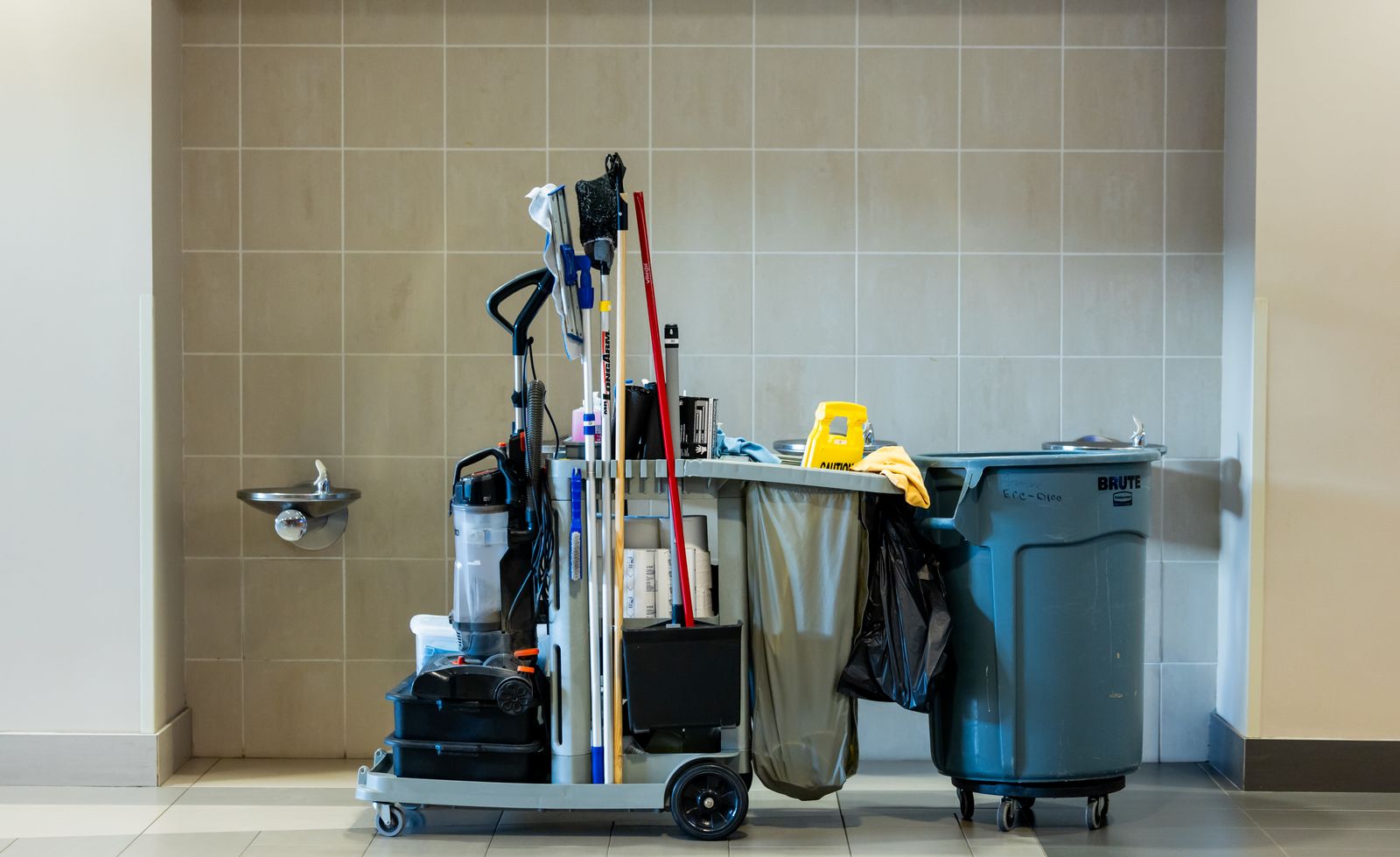Professional janitorial cleaning cart with vacuum, mops and supplies