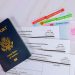 US passport, green card, work permit and USCIS forms on a desk — starting a business without a Social Security number