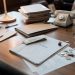 Office desk with tax documents, coins and glasses
